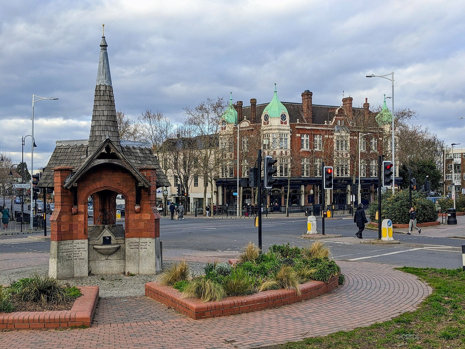 The Victorian drinking fountain on George Green with The George pub behind it