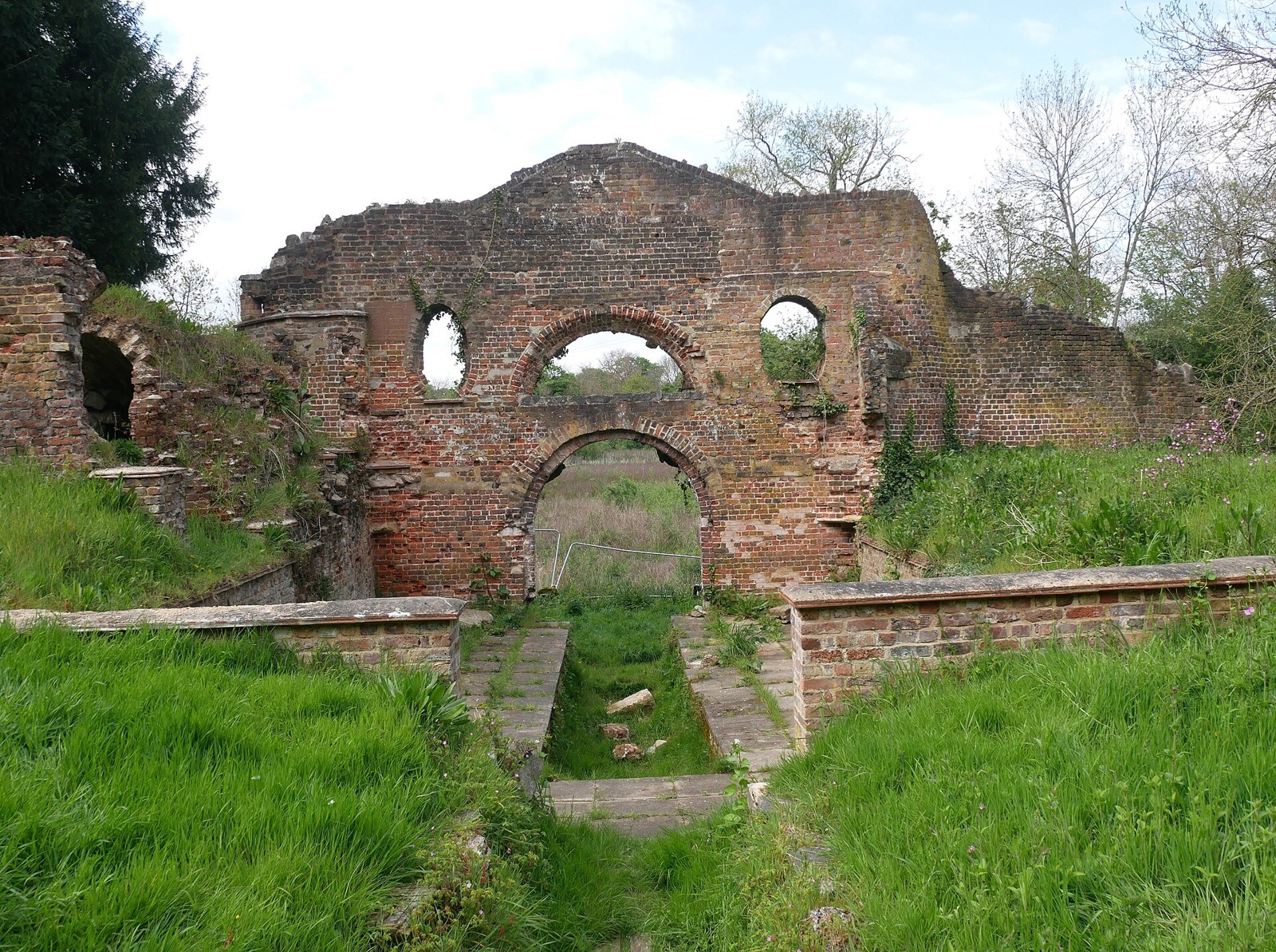 The ruined brick arches of the Grotto in Wanstead Park