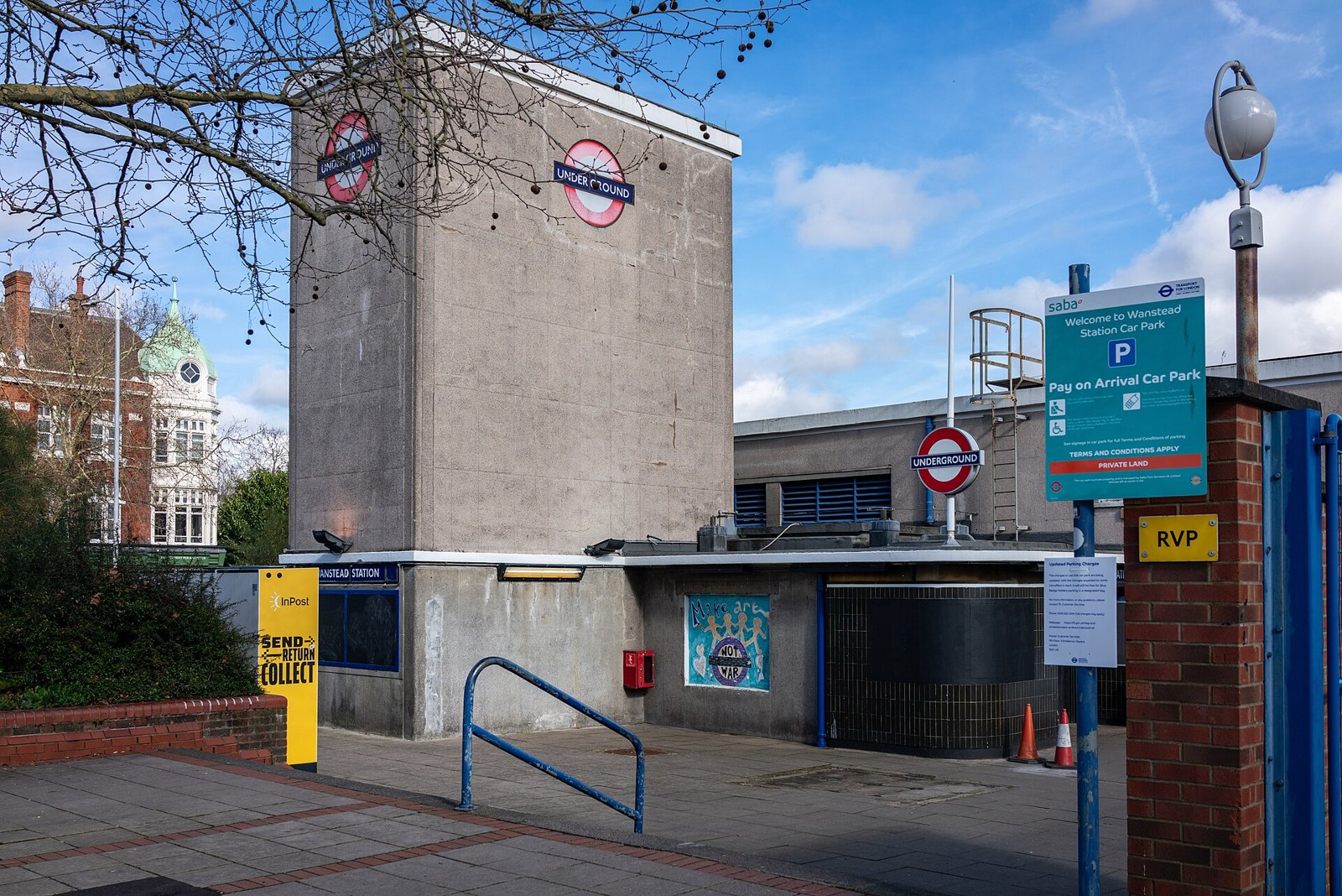 The brick tower and entrance of Wanstead Underground station, with the roundel sign