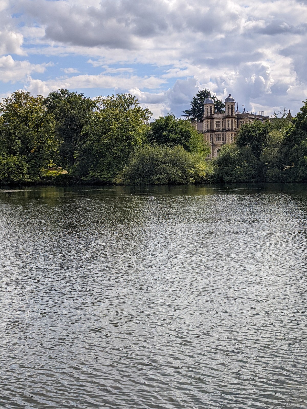 Eagle Pond in Snaresbrook, with the Crown Court building among the trees beyond the water
