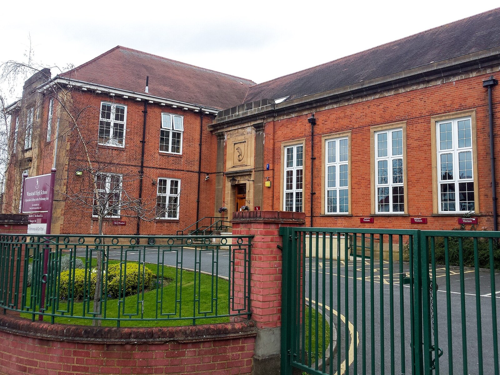 The red-brick buildings of Wanstead High School seen from the street