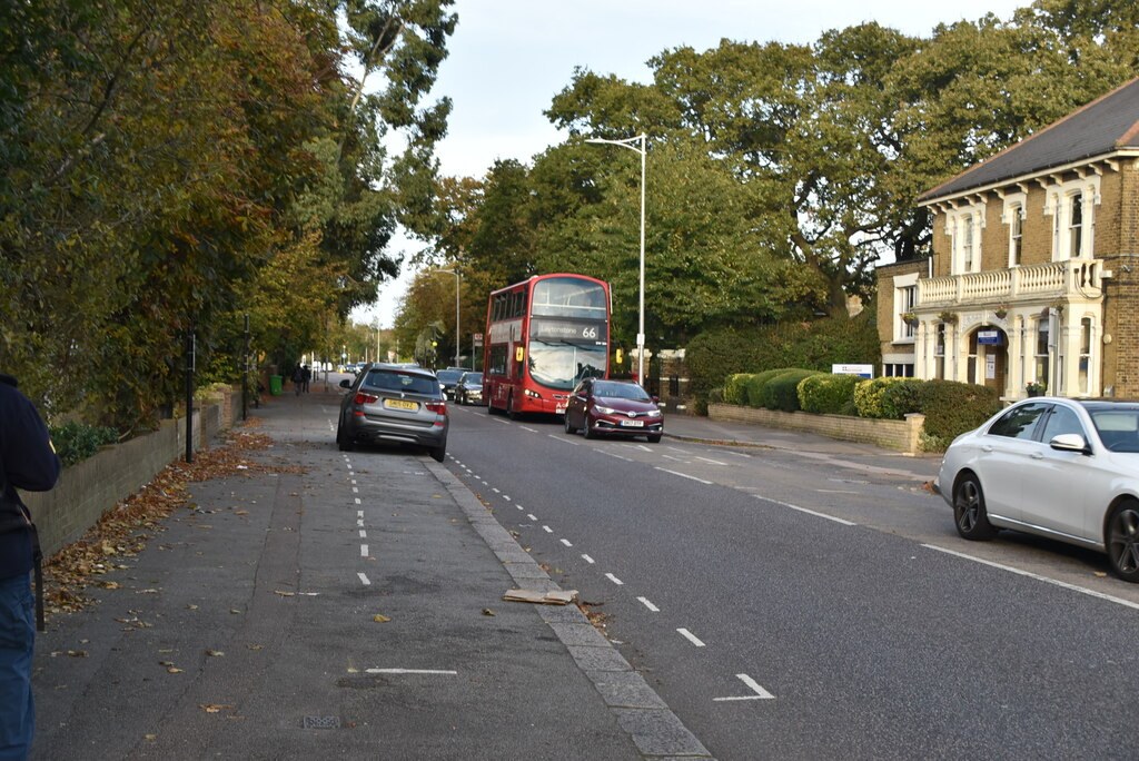 New Wanstead, a wide road with a bus and parked cars