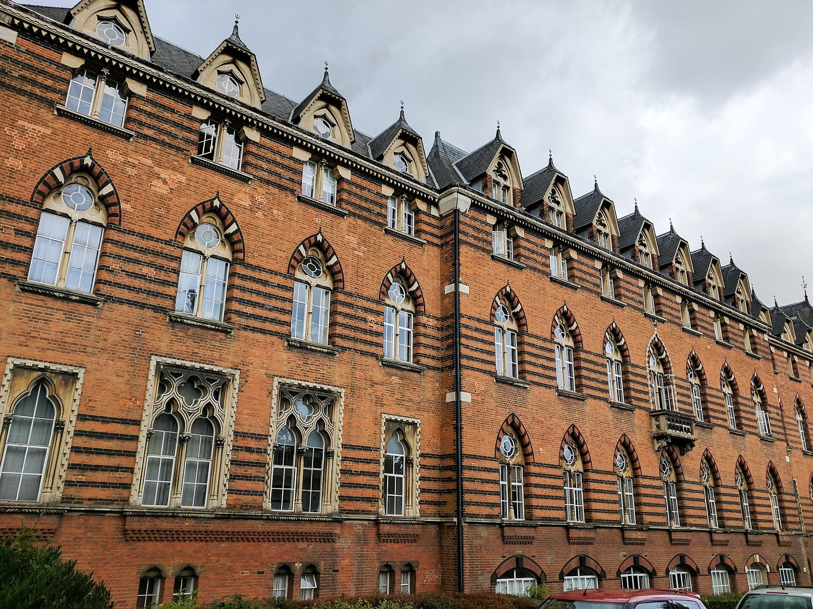 The long red-brick front of the former Merchant Seamen's Orphan Asylum with dark brick bands and gabled dormers