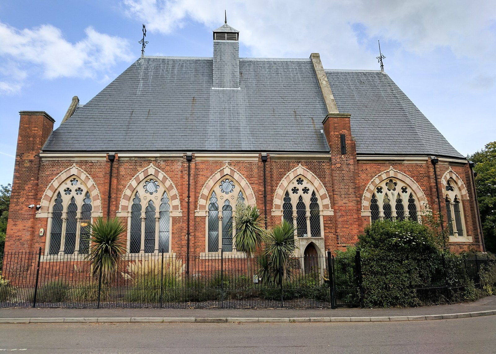 The former hospital chapel, a red-brick building with tall arched windows and a slate roof